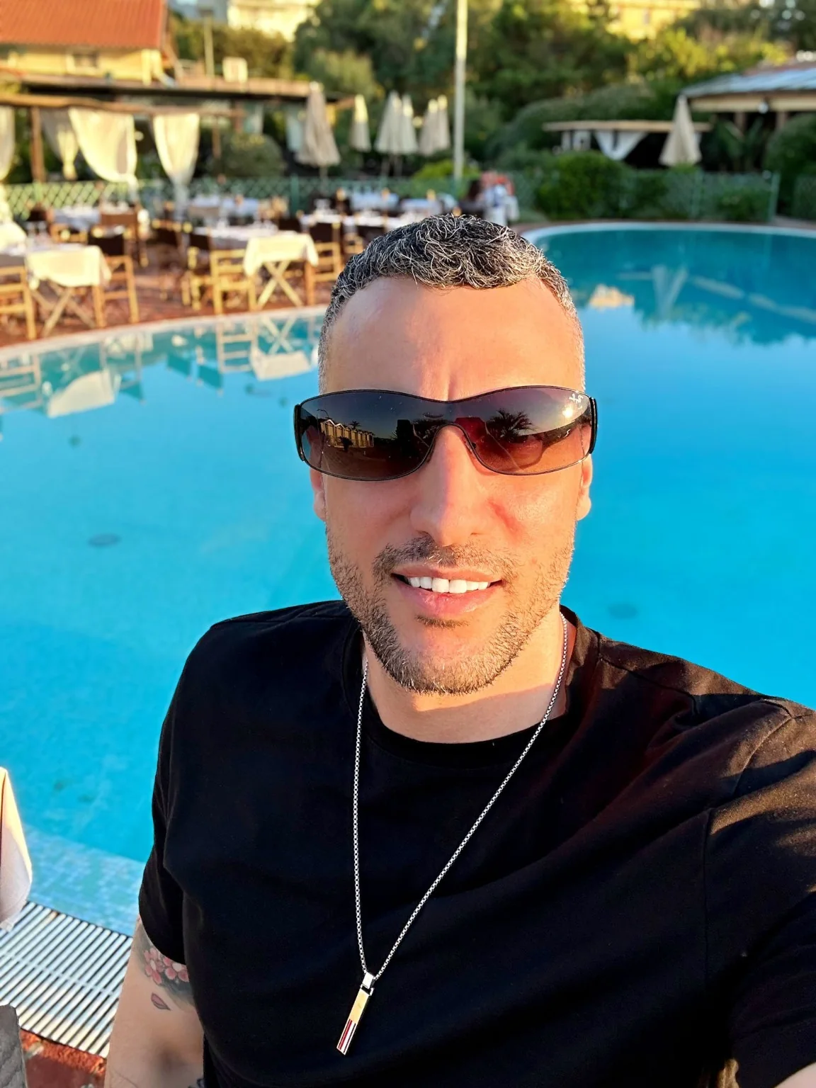 Michael at a pool in a relaxed travel setting