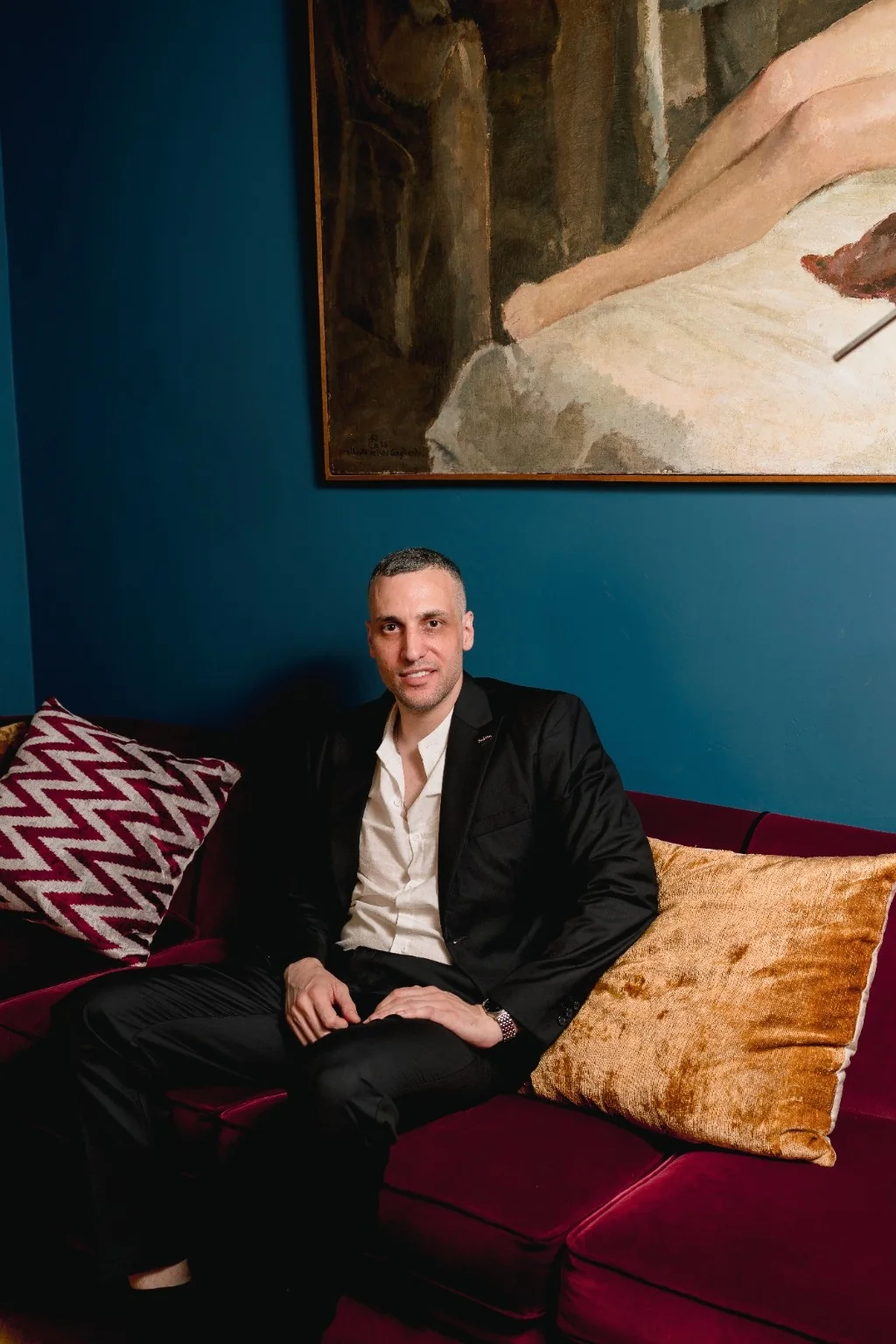 Michael in a black suit in an elegant lounge